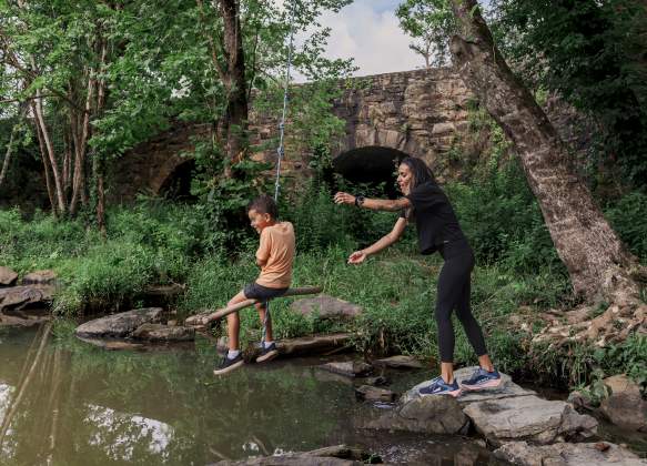 Family Swinging on Rope at Aqueduct Park