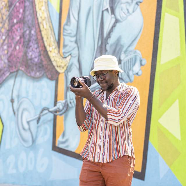 Visitor taking photo of Augusta mural