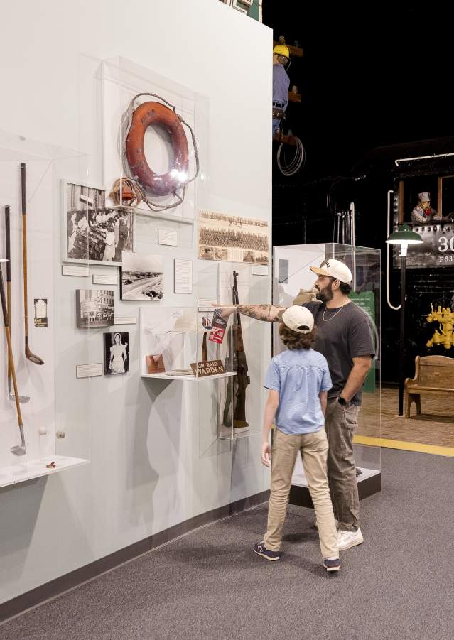 Parent and child discover Augusta's history together while exploring museum exhibits featuring historic artifacts and a restored train engine.