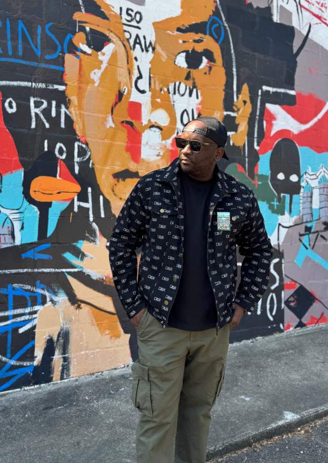 David White in front of Mural