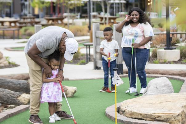 Family Playing Putt-Putt | TopGolf