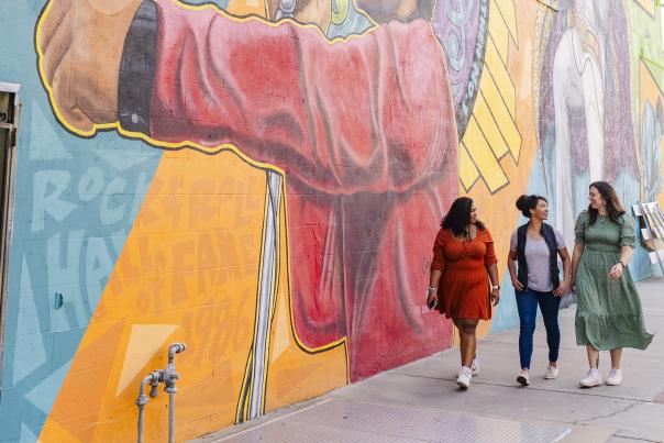 Women in Front of the Spirit of Funk James Brown Mural in Downtown