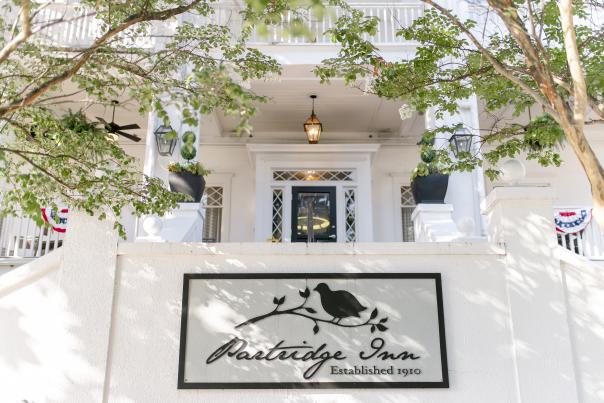 The Partridge Inn - Front Exterior View/Sign with Flags