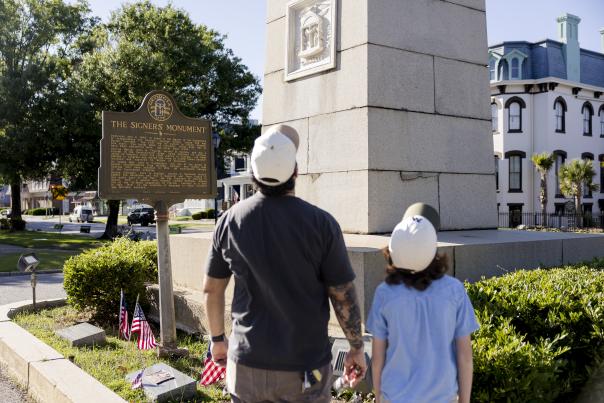 Father and son view the Signers Monument in downtown Augusta, Georgia, honoring Georgia's signers of the Declaration of Independence.
