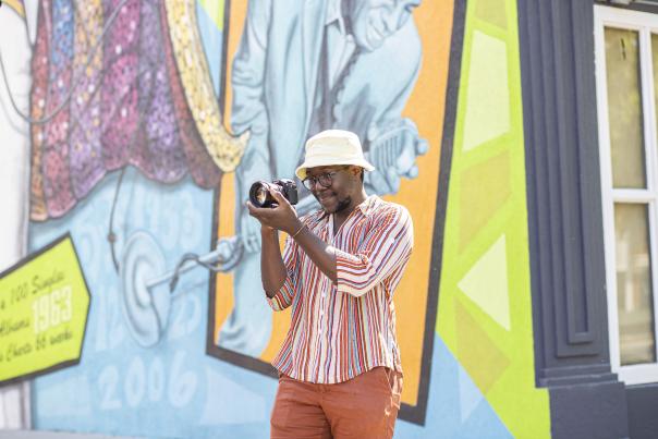 Visitor taking photo of Augusta mural