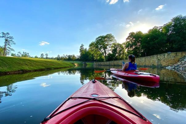 Friends Kayaking Down a Lake In Augusta