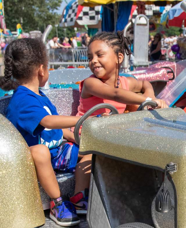 Kids riding a carnival attraction at the Calhoun County Fair in Michigan.