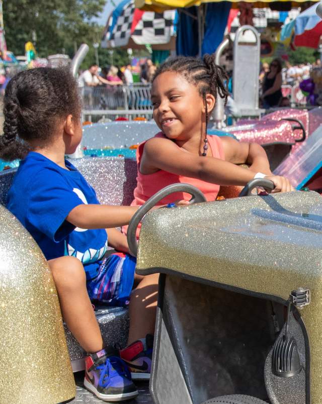 Kids riding a carnival attraction at the Calhoun County Fair in Michigan.