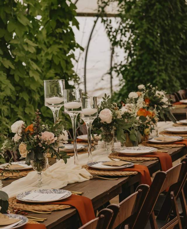 Of the Land is a farm, event venue and caterer. They have a Green Box, which uses products from local farms. Weddings, open houses, yoga -- the greenhouse venue has many uses. There is a garden with seating, bonfire spaces and a farmhouse. Photos 2022