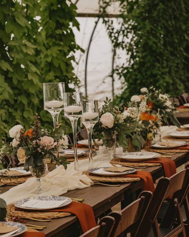 Of the Land is a farm, event venue and caterer. They have a Green Box, which uses products from local farms. Weddings, open houses, yoga -- the greenhouse venue has many uses. There is a garden with seating, bonfire spaces and a farmhouse. Photos 2022