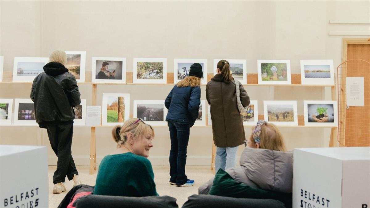 Visitors looking at art in a Belfast gallery