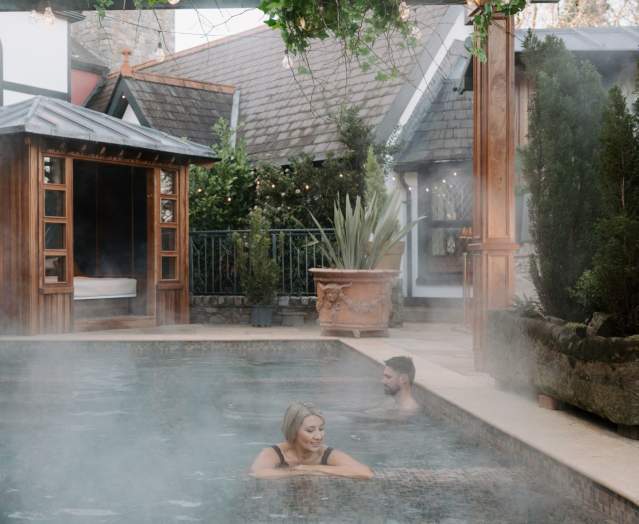 Couple in pool at Old Inn's Treetop Spa