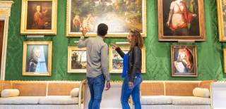 A couple looking at the artwork inside Hillsborough Castle and Gardens.