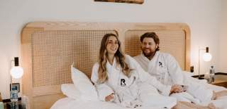 Couple laying on bed at The Rabbit