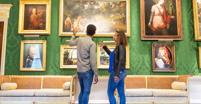 A couple looking at the artwork inside Hillsborough Castle and Gardens.