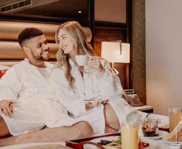 Couple enjoying breakfast in bed at Grand Central