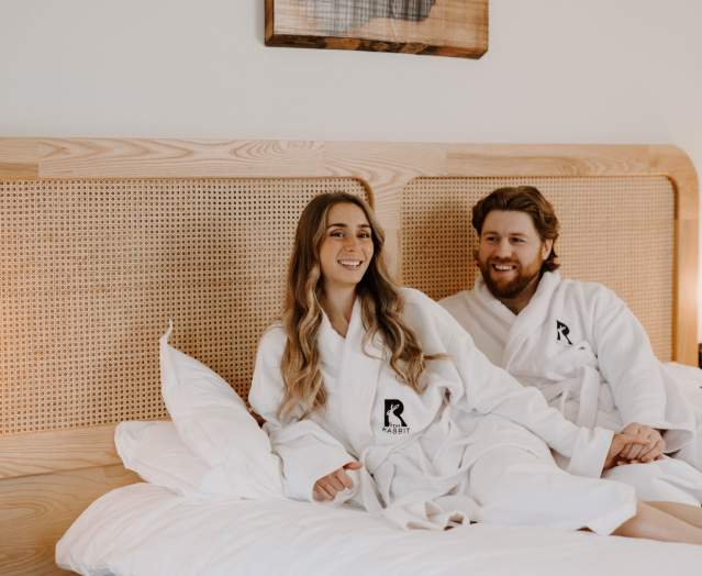 Couple laying on bed at The Rabbit