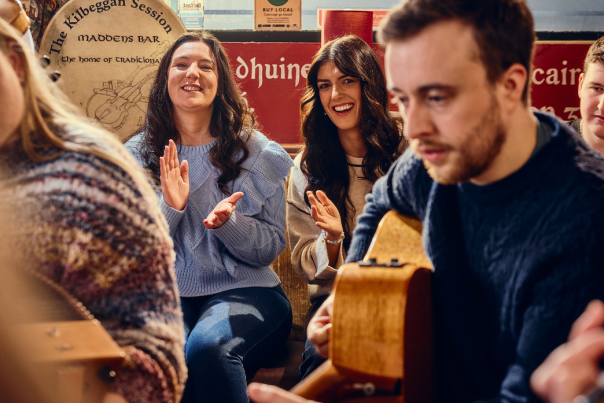 People playing the guitar in Belfast.