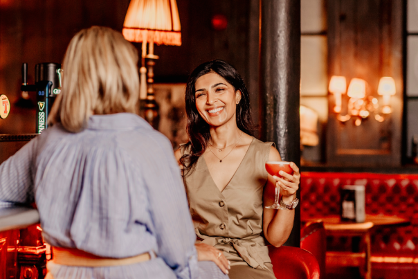 Image of two girls enjoying drinks in Belfast bar