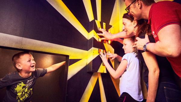 Family enjoying one of the puzzle rooms at Prison Island Belfast.