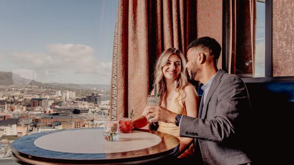 A couple enjoying cocktails in the Observatory bar in the Grand Central Hotel.