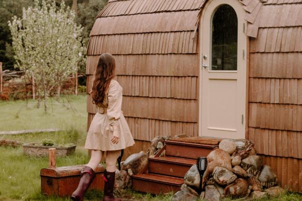 Woman entering glamping pod at Enniskeen Estate