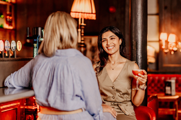 Image of two girls enjoying drinks in Belfast bar