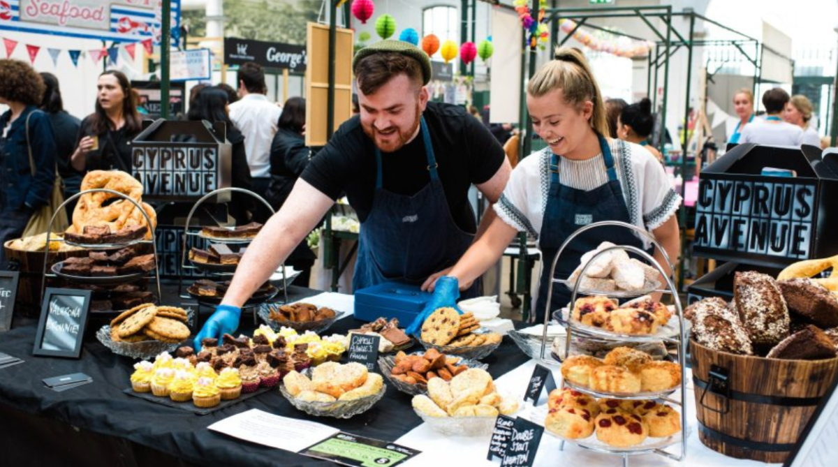 People at a stall in George's market serving food