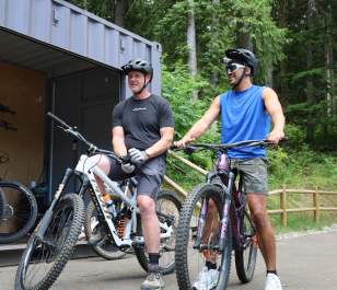 Two cyclists ride bikes from The Line Experience