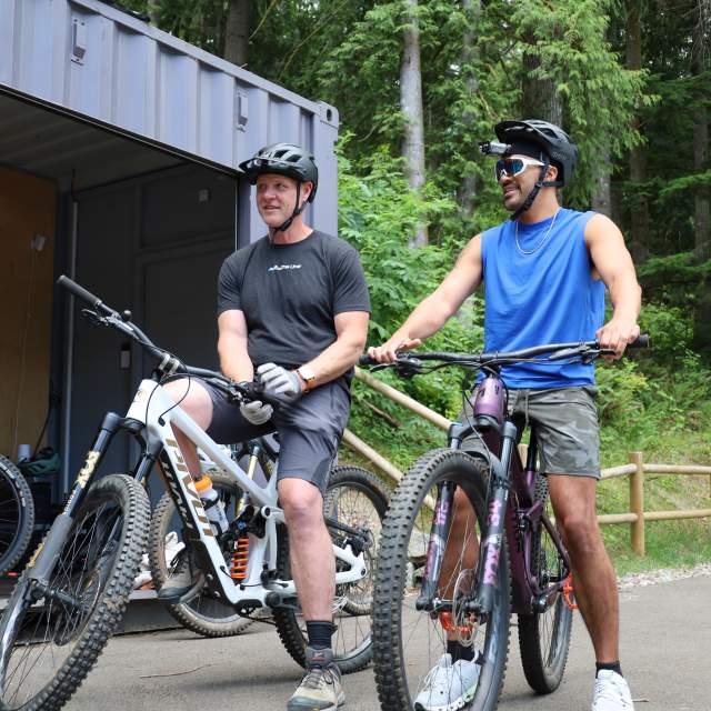 Two cyclists ride bikes from The Line Experience
