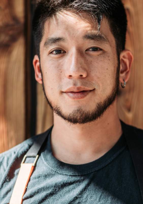 Chef preparing culinary creations in Bellevue, Washington, standing in a restaurant setting as featured in Bellevue Eats and local dining experiences.