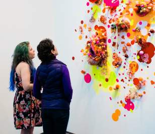 Couple exploring bright contemporary gallery display