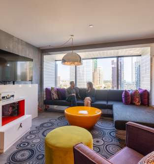 Interior of a Suite style Hotel Room with TV, Sofa, Armchair, wet bar