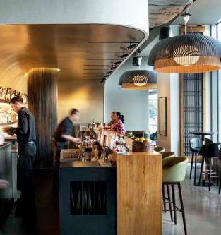 Wild Ginger Bellevue Bar stylish interior featuring sleek design, vibrant lighting, and patrons enjoying drinks and conversations in a modern setting.