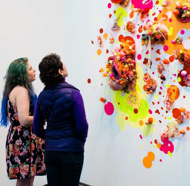 Couple exploring bright contemporary gallery display