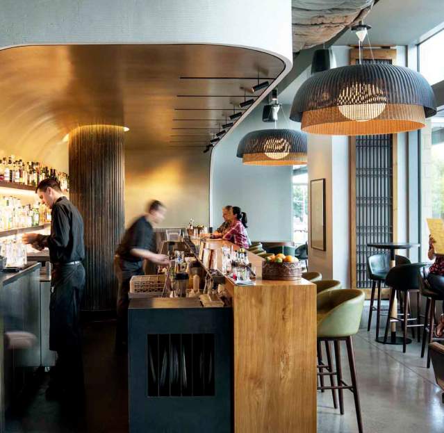 Wild Ginger Bellevue Bar stylish interior featuring sleek design, vibrant lighting, and patrons enjoying drinks and conversations in a modern setting.