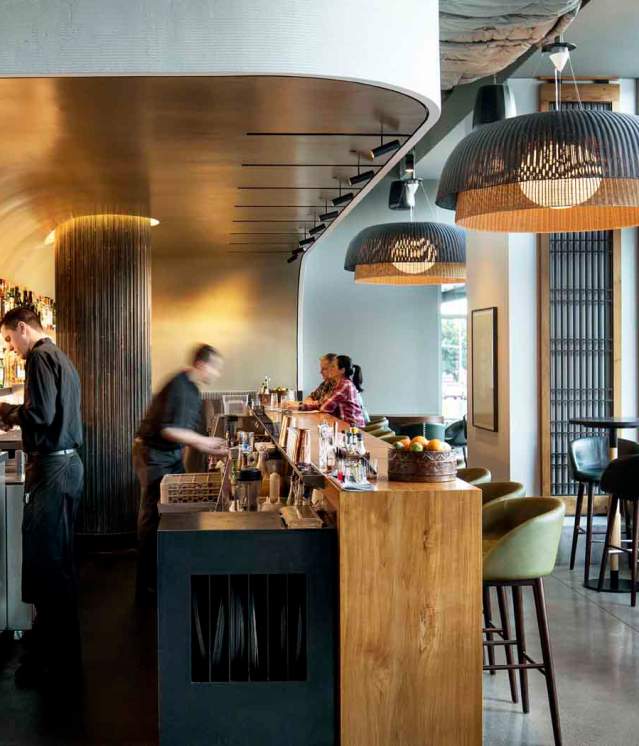 Wild Ginger Bellevue Bar stylish interior featuring sleek design, vibrant lighting, and patrons enjoying drinks and conversations in a modern setting.