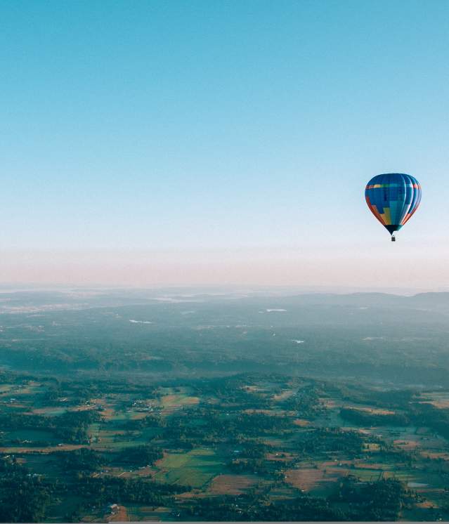 Passengers enjoy the scenic beauty of the Pacific Northwest from the basket of hot-air balloons.
