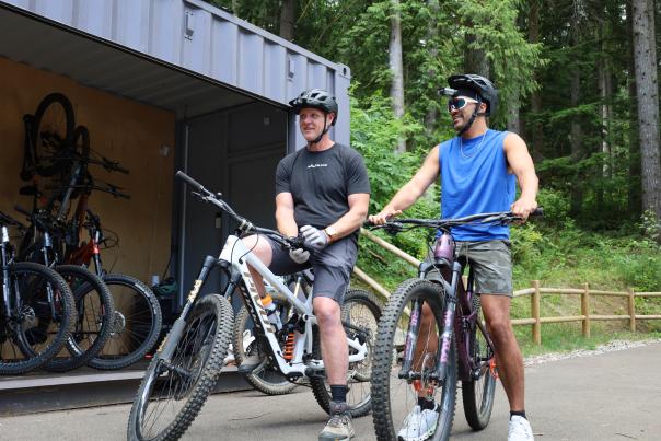 Two cyclists ride bikes from The Line Experience