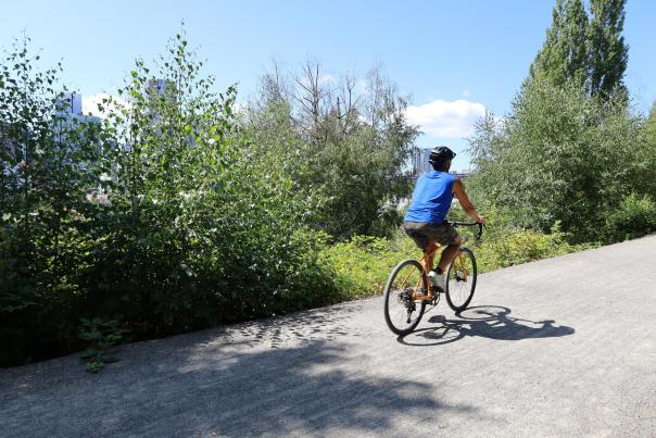 Cyclist rides the Bellevue Eastrail at The Line Bike Experience Kiosk