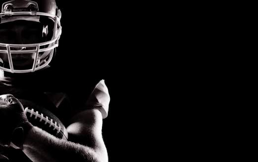 Football player holding a football