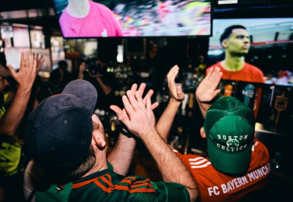 Crowd watching soccer at a Boston sports bar