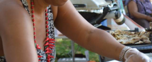 Caribbean woman preparing food at a festival