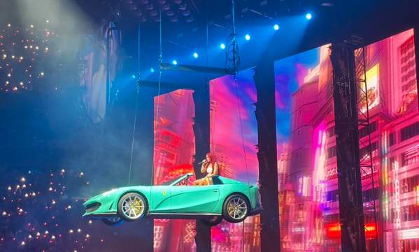 Karol G floating in a car during her performance in TD Garden