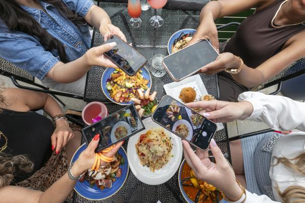 People taking pictures of food at 75 Liberty
