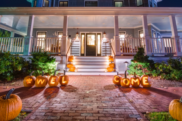 The Inn at Hastings decorated with pumpkins lit up along the front walkway.