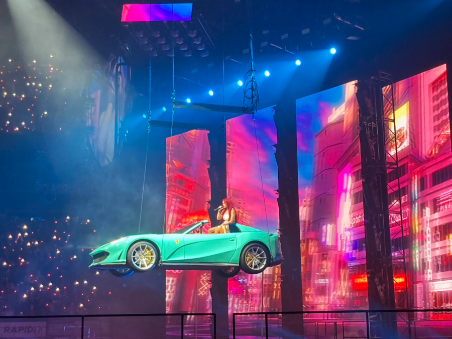 Karol G floating in a car during her performance in TD Garden