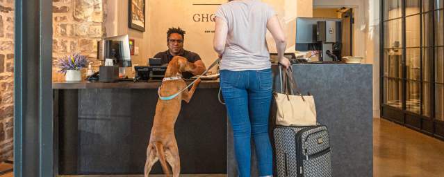 Woman and dog checking in at the pet-friendly Ghost Light Inn