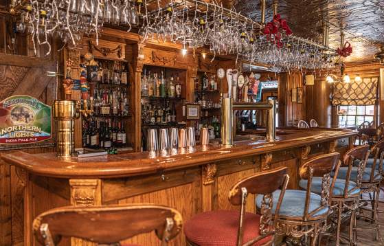 Antique wooden bar with artistic carved wood details and vintage charm