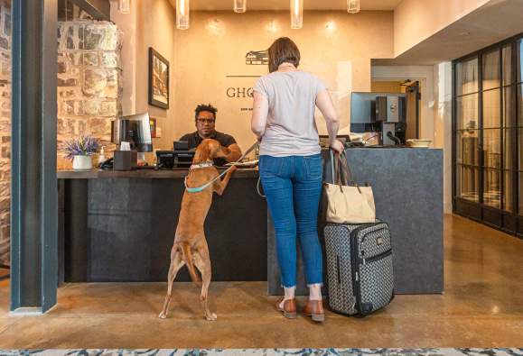 Woman and dog checking in at the pet-friendly Ghost Light Inn